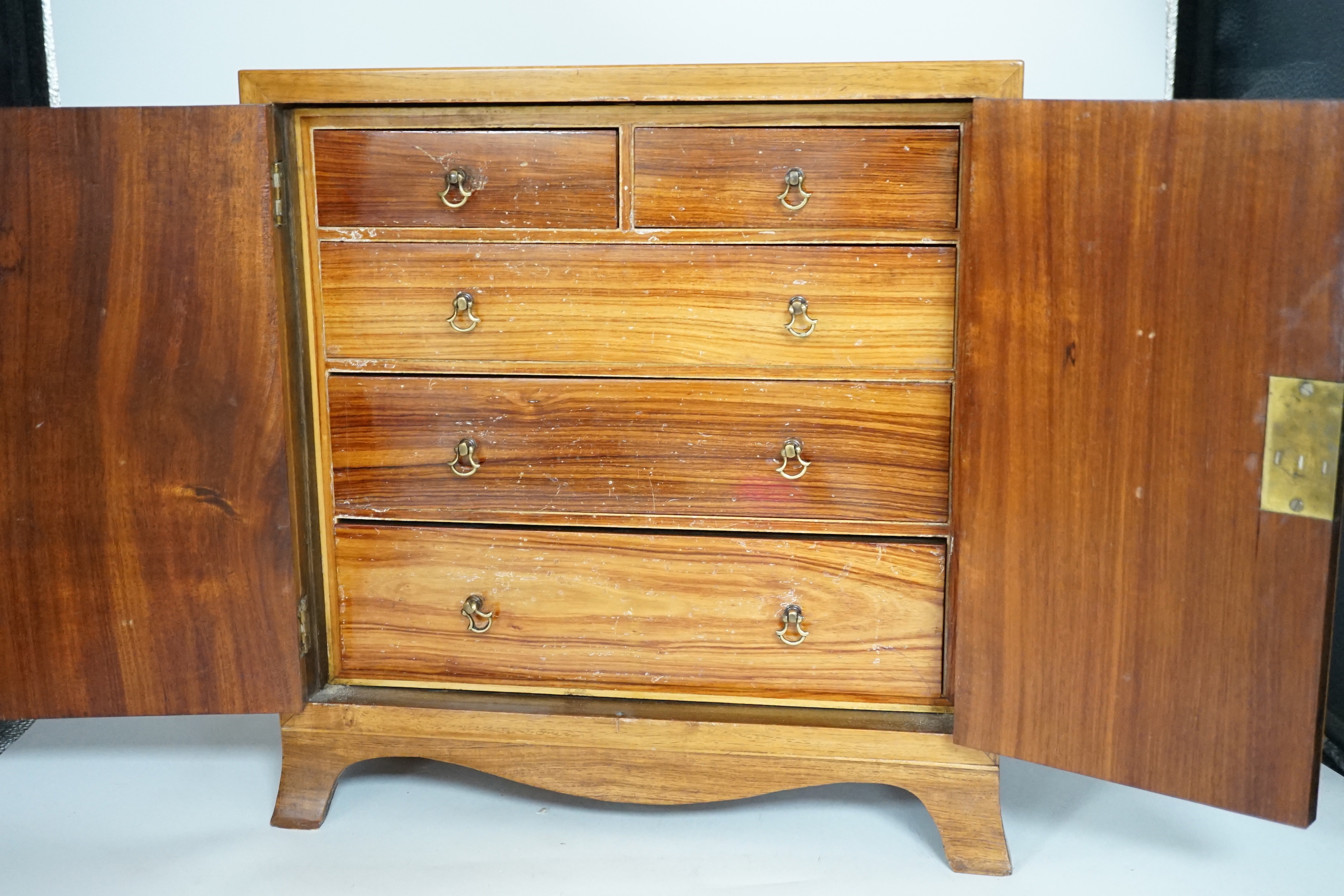 A George III style rosewood and tulipwood banded miniature two door chest, fitted with four graduated drawers, 36 x 35cm